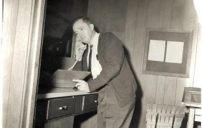 Butcher working and answering phone