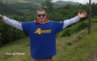 A man wearing a Butcher AC t-shirt for the Tour de France