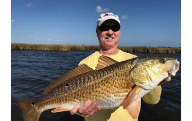 Butcher AC team member with a fresh caught fish