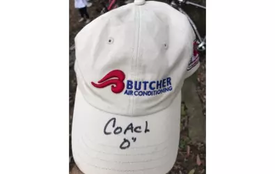 Butcher AC hat with Coach D's autograph
