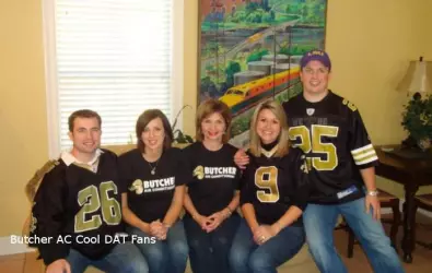 Photo of people wearing black and gold Butcher company shirts to celebrate the Saints football team