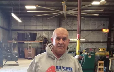 photo of a man wearing a Butcher sweatshirt in the company workshop