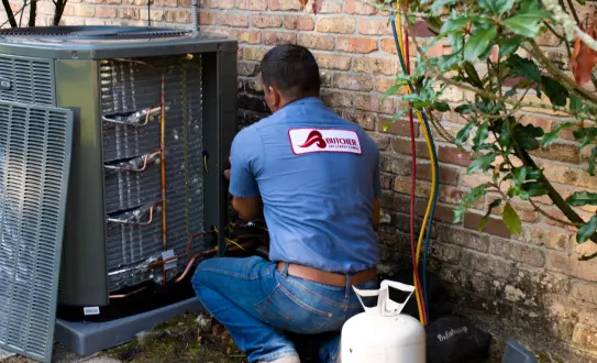 image of Butcher air conditioning technician repairing an AC unit