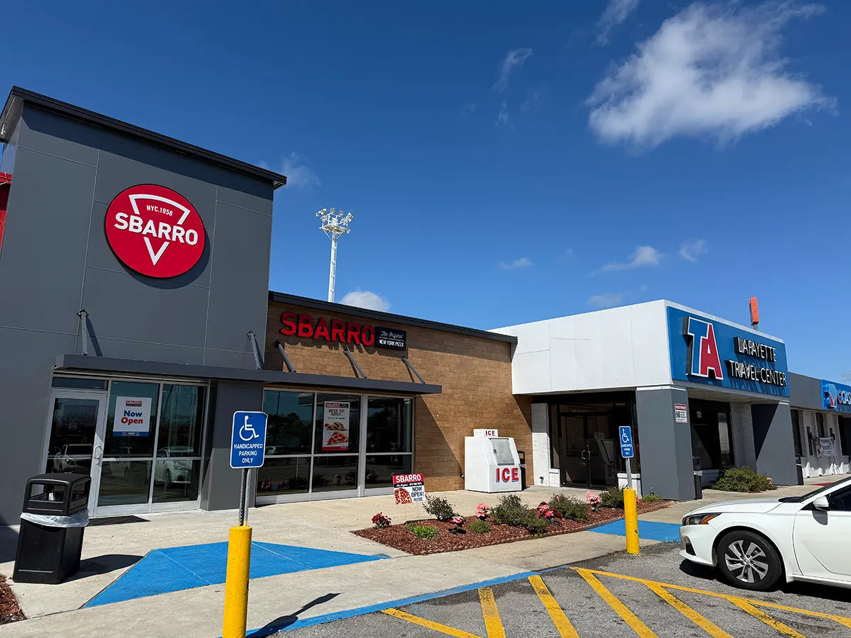 Sbarro restaurant storefront next to TA Lafayette Travel Center with handicap parking, ice machine and clear blue sky