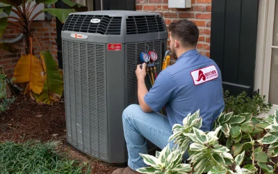 Technician inspecting a Trane outdoor air conditioning unit with pressure gauges, residential HVAC maintenance