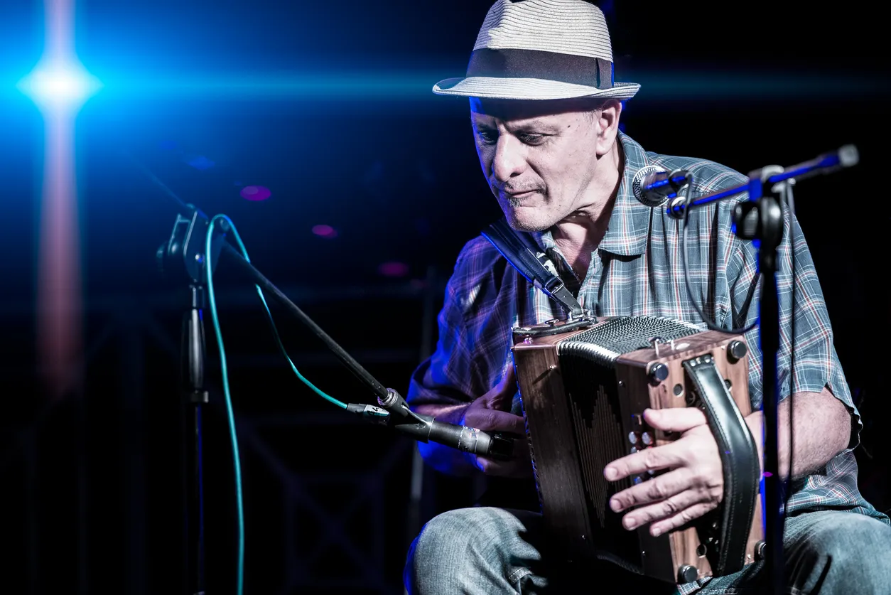 An accordion player playing traditional Cajun-style music at the KBON Cajun Music Festival.